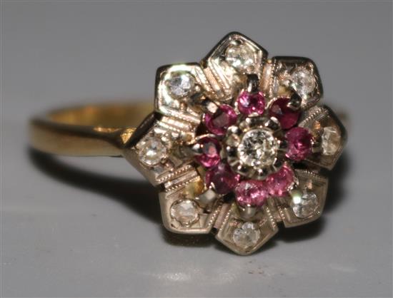 An 18ct gold ruby and diamond cluster ring, size N.